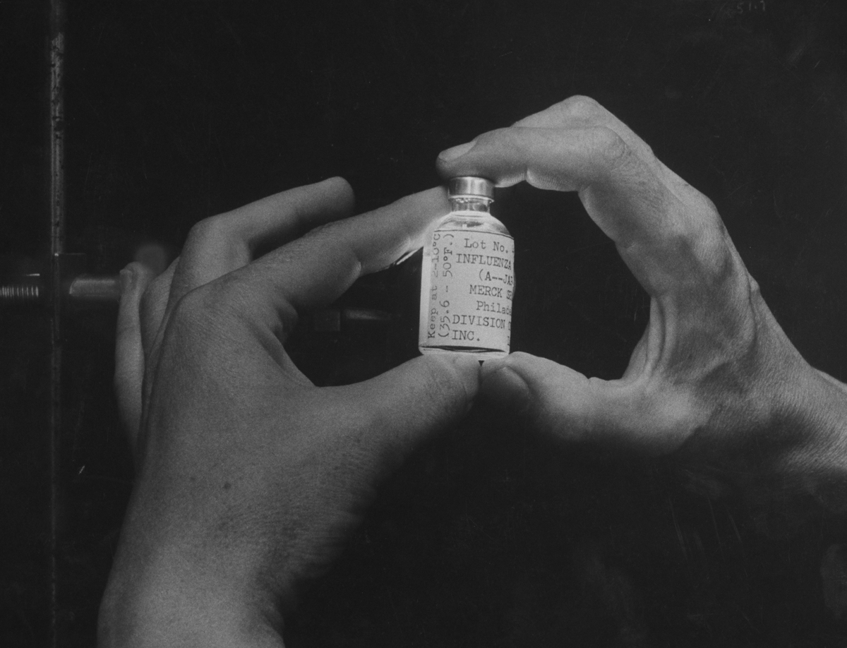 Hands holding influenza vaccine, 1957